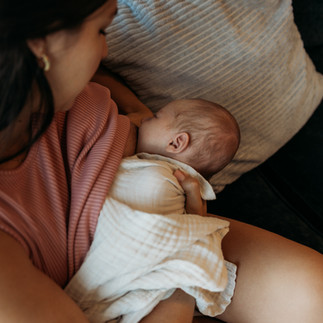 lifestyle newborn photoshoot downtown orlando highrise apartment. mama nursing baby