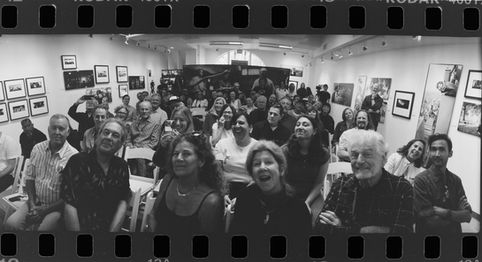 A smiling crowd at the Jeff Bridges Photography Exhibition