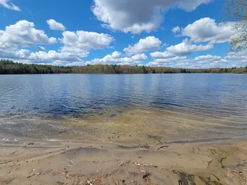 Beautiful view of Graham Lake with clear blue sky and calm water at Graham Lake Oasis in Mallorytown, Ontario.