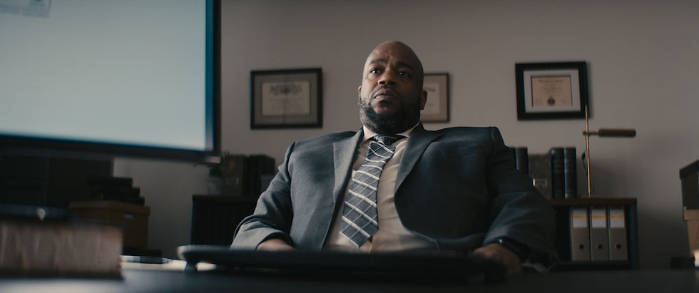 Film frame of man dramatically leaning back in office chair.