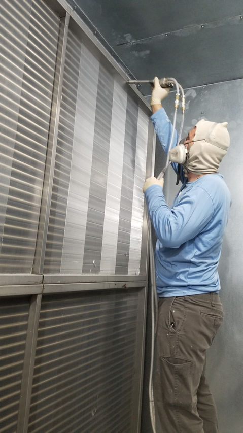 EPS shop foreman coating an air handler coil with CoilSafe at Ben Taub Hospital