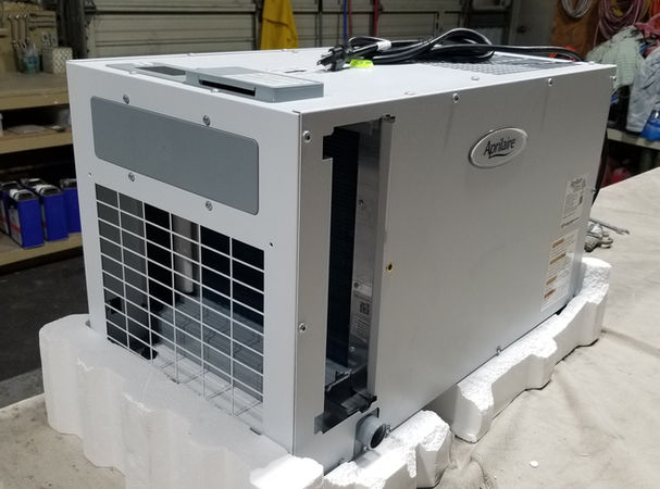 Dehumidifier sitting on table in shop.