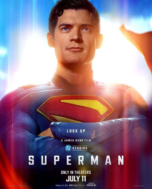 Superman in his uniform in front of a blue sky.