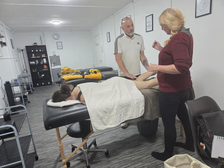 Student learning sports massage techniques during professional training with Holistic Therapies Training Academy in Bideford, North Devon.