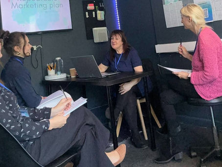 Tutor teaching vocational therapy students with Holistic Therapies Training Academy.