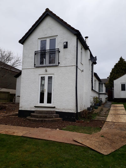 side view of old and worn down house with brown tiling area