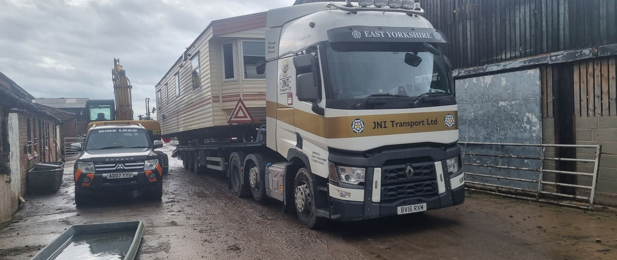 JNI Transport Ltd load in progress on muddy road