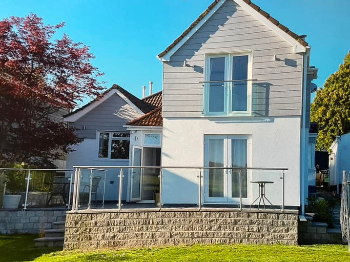 modern white and grey house after LMT Roofing and Building Ltd construction works