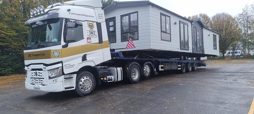 JNI Transport Ltd truck carrying caravan