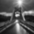 Simple, grayscale image of a bridge going left to right just after the rain with a bright