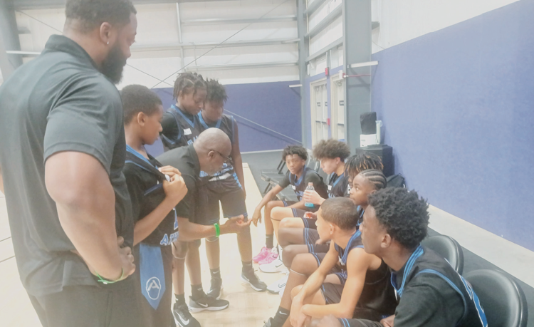 The B.A.L.D.Y. Athletics 7th Grade/13U boys team huddles up during a game at the AAU World Championships at ESPN Wide World of Sports at Disney World. The team consists mostly of local Daytona kids.