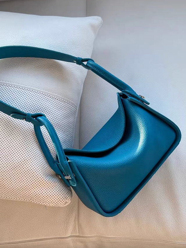 Toga embossed calf leather handle + crossbody drape flap bag 1