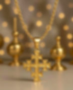Gold necklace with Krst Svetog Djordja - Serbian Orthodox cross gold pendant against bokeh background.