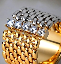 Gold and silver ring, cubic zirconia on top, jewelry detail, close-up view.