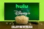 Streaming ad setup with Hulu and Disney+ logos on screen, a bowl of popcorn, and a remote on a table. Promotes Enjoy New Media’s video production for connected TV advertising.