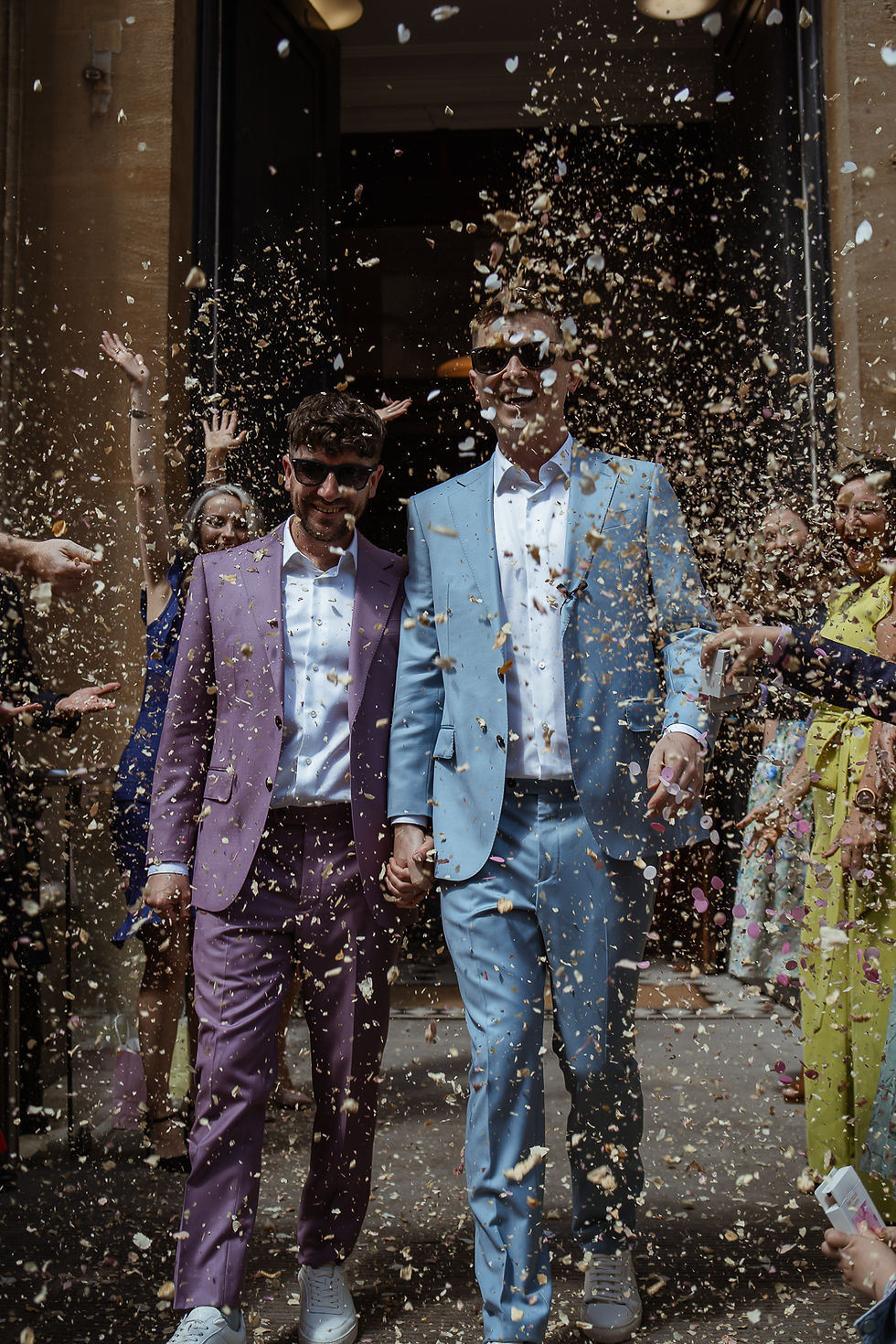 LGBTQ+ couple celebrate with confetti after their wedding ceremony at Bristol Registry captured by LGBTQ+ wedding photographer Rebel Love Club