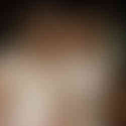 Lesbian couple on their wedding day smiling at each other with colourful bouquets captured by Feminist & LGBTQ+ wedding photographer, Rebel Love Club