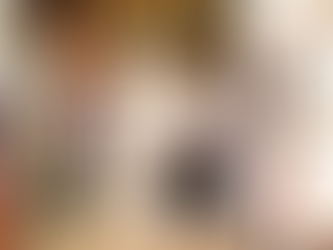 Happy couple sit down together during their wedding ceremony led by Louise from Kissass Gatherings. Louise wars a multicolored jumpsuit and has orange hair. Kickass Gatherings are an LGBTQ+ friendly supplier, part of the Rebel Love Directory.