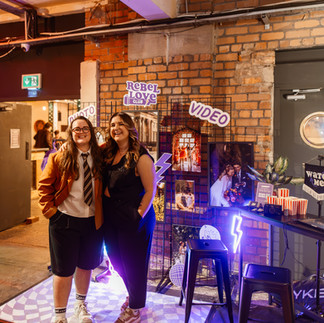 LGBTQ+ couples browsing the LGBTQ+ inclusive wedding suppliers at Rebel Love Wedding Fair