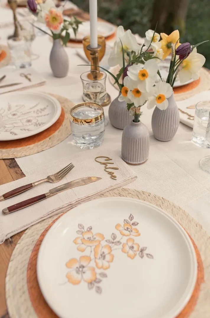 Wedding breakfast table decoration, using white and neutral colors and floral patterns. Supplied and decorated by Disco Dining, an LGBTQ+ wedding supplier part of the Rebel Love Directory
