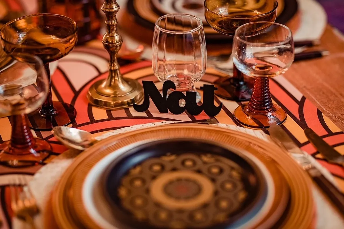 Wedding breakfast table decoration, using gold and neutral colors. Supplied and decorated by Disco Dining, an LGBTQ+ wedding supplier part of the Rebel Love Directory