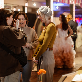 LGBTQ+ couples browsing the LGBTQ+ inclusive wedding suppliers at Rebel Love Wedding Fair