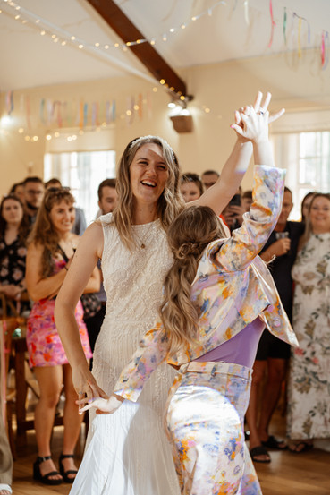 Brides dance their first dance together, captured by Rebel Love Club