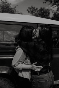 Black and white photo of queer lovers embrace. Captured by LGBTQ+ friendly wedding photographer, Blue Hare Photography, part of the Rebel Love Directory.