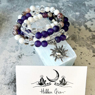 Purple, white and clear crystal bracelet with a silver sun charm. Hidden Gem is a LGBTQ+ Favours & gifts wedding supplier, part of the Rebel Love Directory.