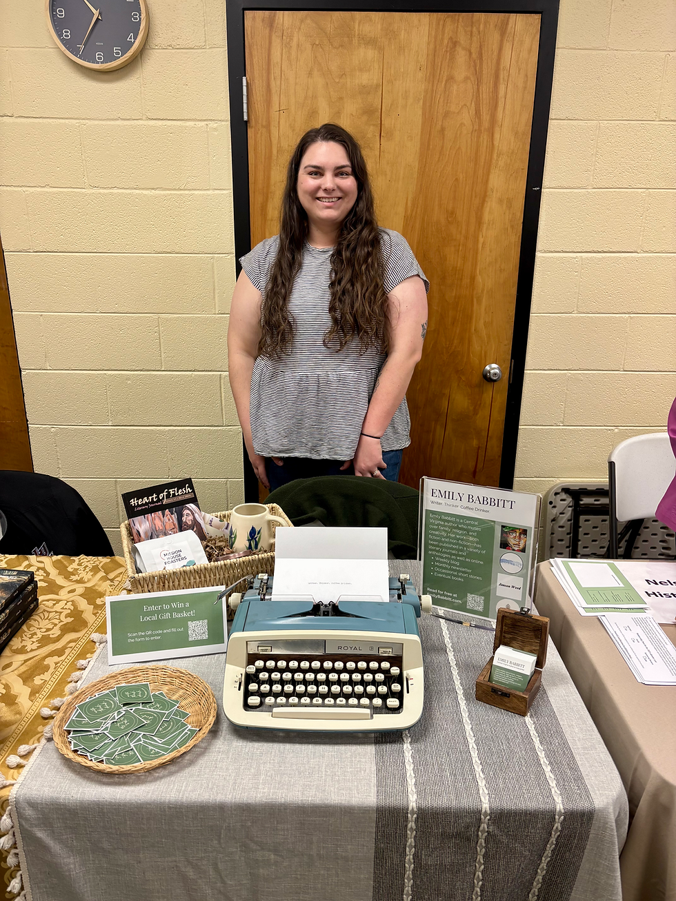 A woman stands behind a table with a typewriter and some books on it.