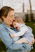 Mother hugging toddler during outdoor family session in Wilton, CT