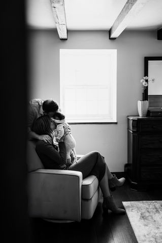 Cozy newborn cuddles during in-home lifestyle session in Connecticut
