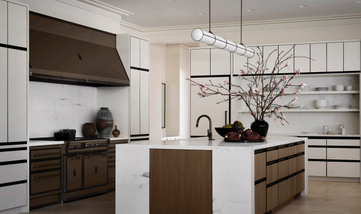 Modern kitchen with island, cabinets, and appliances offering a luxurious design.