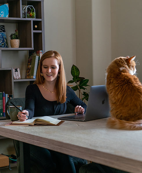 Nikki Nandrasy working on Retainer Program Clients with cat