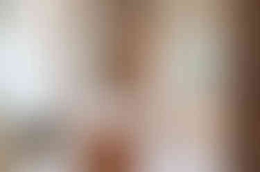 Warm wood vanity with honed Rhino White Marble top.