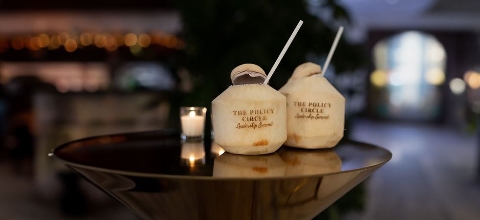 Two coconuts with straws and The Policy Circle summit logo
