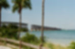 Old Seven Mile Bridge in Florida Keys over turquoise water, palm trees.