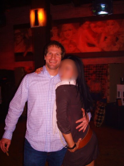 Man and woman posing together at a dimly lit bar; Matt Pitcher