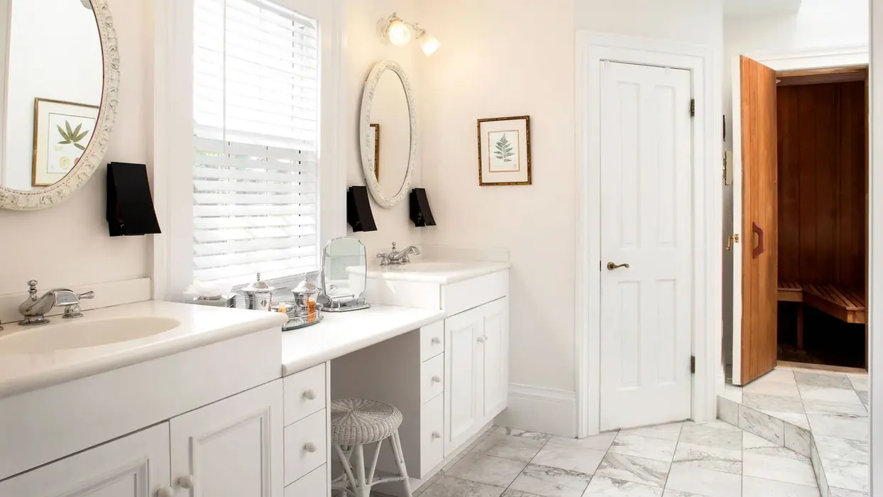 Master suite bathroom with double vanity and marble floor