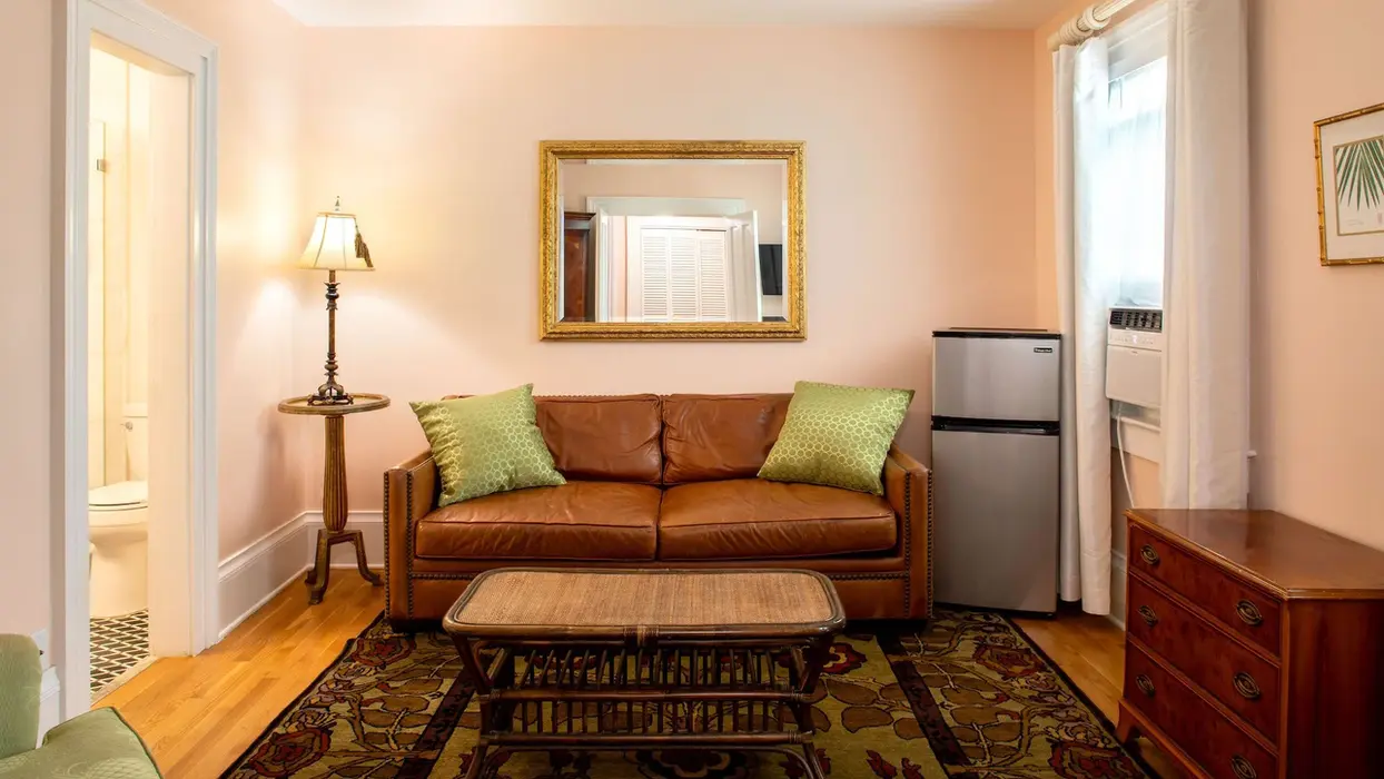 Brown leather sofa and coffee table in a master suite.