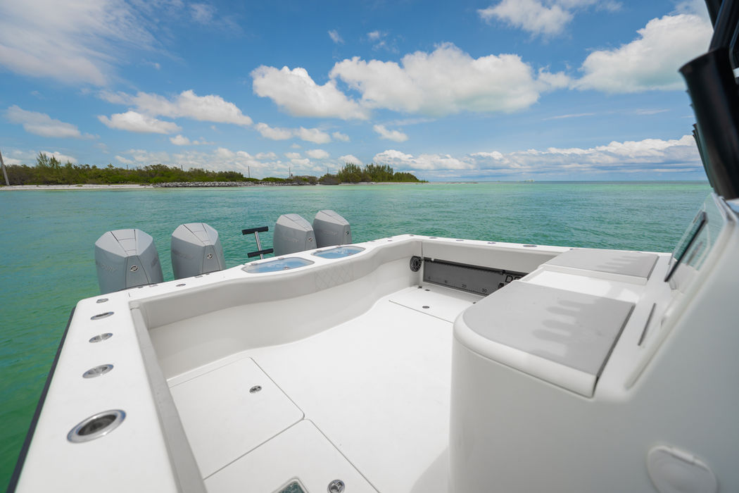 Our white boat with four powerful engines on turquoise water