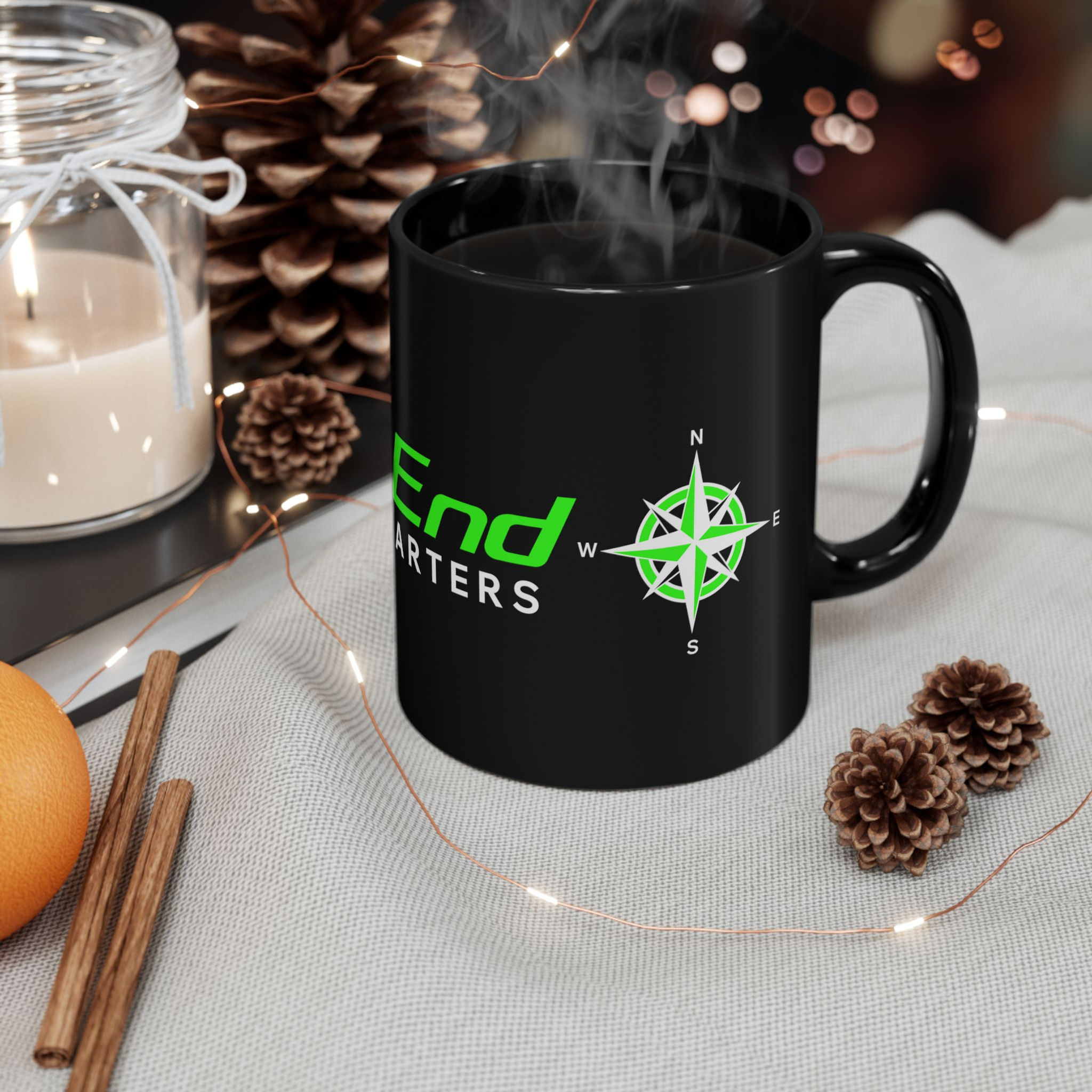 Black mug with Deep End Charters logo and compass