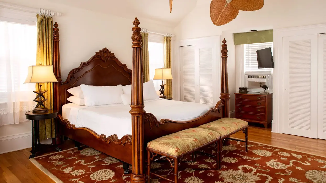 Four-poster wooden bed in a master suite