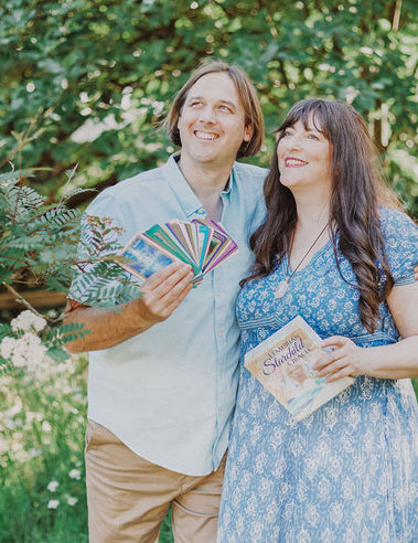 Michiel showing Lemurian Starchild Oracle cards and Leanne showing Lemurian Starchild Oracle box, both looking up.