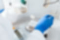 Closeup of pharmacist hand holding bottle while weighing white powder chemical in a labora