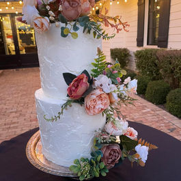 Textured Two Tier Wedding Cake with several flowers 