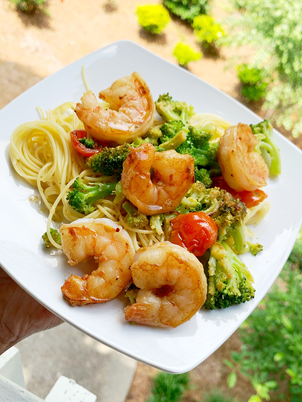 garlic shrimp scampi with angel hair pasta, broccoli, cherry tomatoes, and garlic butter sauce