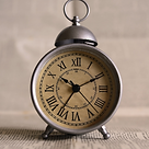 A brown desk clock with bell stating the fast payment turnaround for claims.