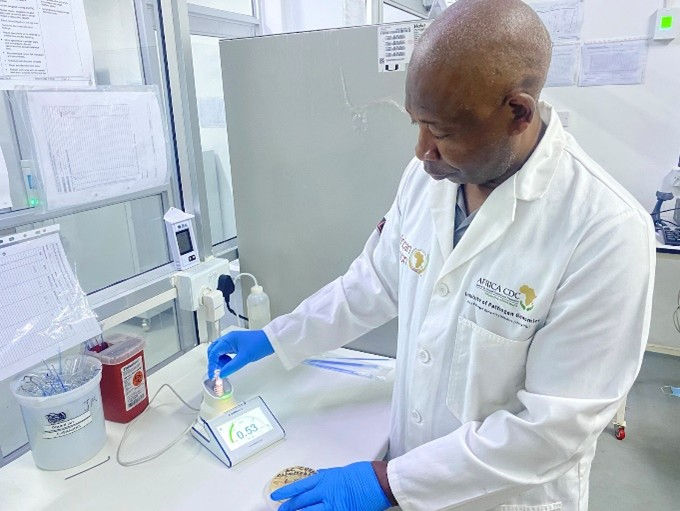 At the NMRL, Hlanai Gumbo is picking an A. baumannii isolate to standardize the microbial suspension using the McFarland test before initiating AST. 