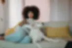 dog and woman watching tv on couch